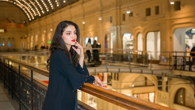 A girl with a beautiful figure in a shopping center