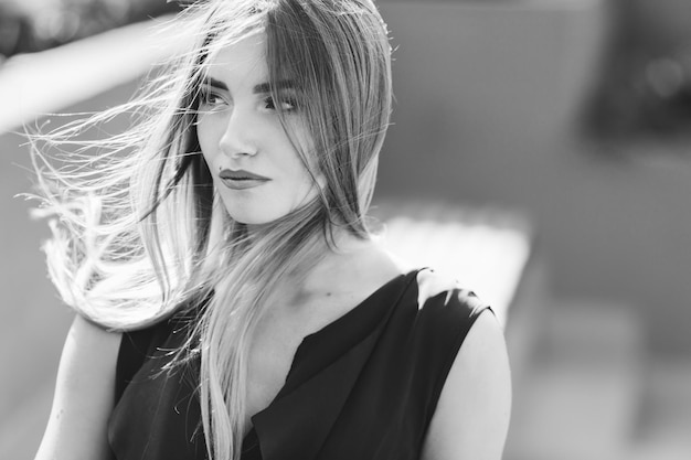 A girl with a beautiful makeup looks into the camera closeup