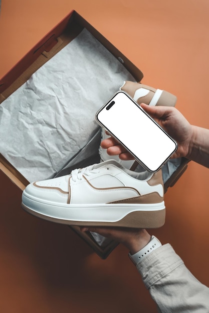 Girl with blank screen phone and parcel