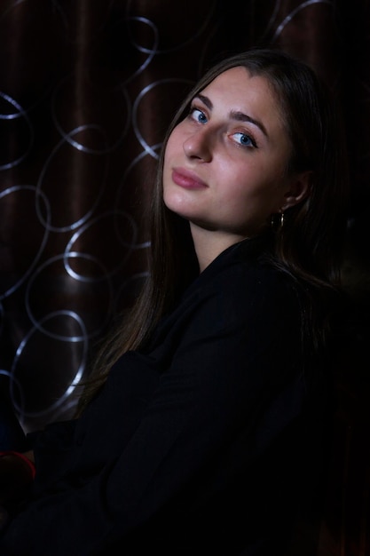 A girl with blue eyes on a dark background