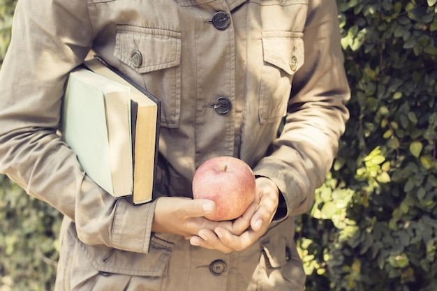 GIrl with books and a apple