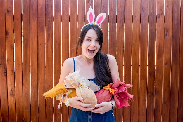 Girl with bunny ears holding easter eggs