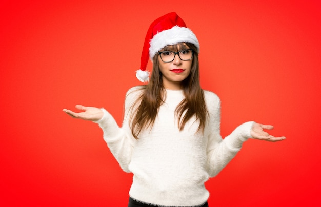 Girl with celebrating the christmas holidays having doubts and with confuse face expressio