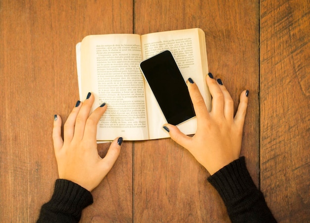 Girl with cell phone and book