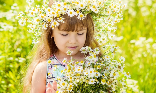 Girl with chamomile. Selective focus. nature flowers.