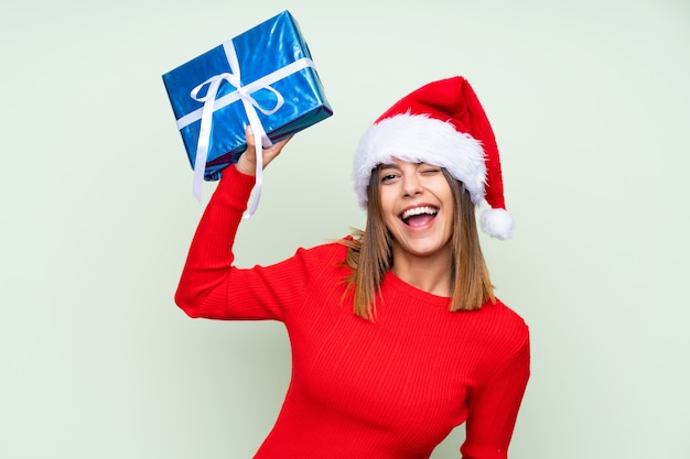 Girl with christmas hat over isolated green