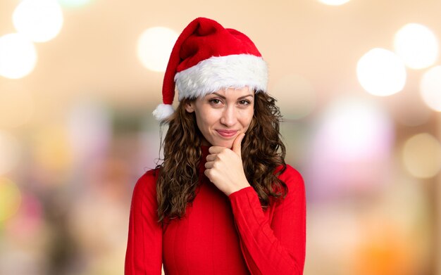 Girl with christmas hat laughing over unfocused background