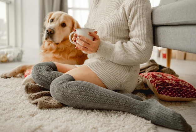 Girl with cocoa and golden retriever dog