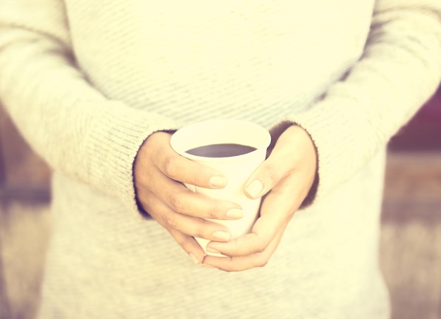 Girl with coffee mug outdoors