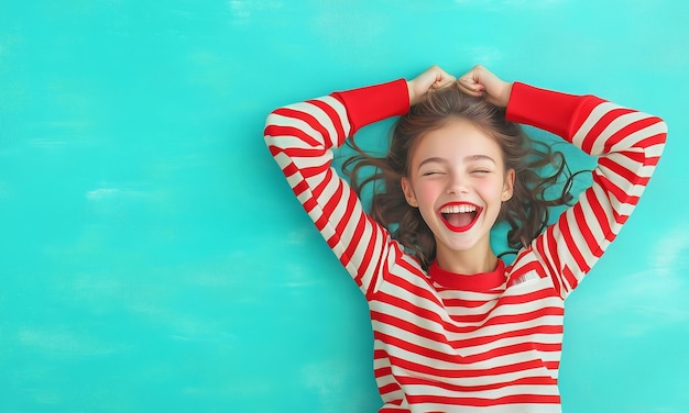 Photo girl with curly hair smiles joyfully against a teal background