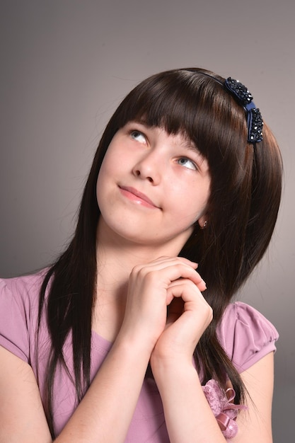 Girl with dark hair posing in studio