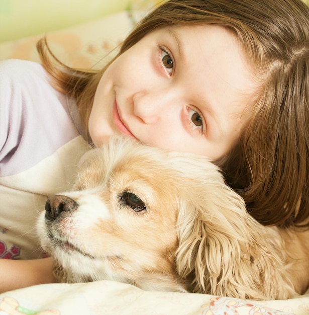 Girl with dog looking at the camera