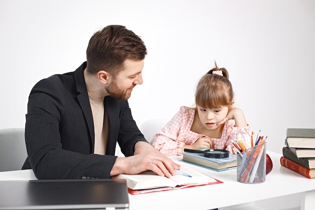 Girl with Down syndrome studying with her teacher at home