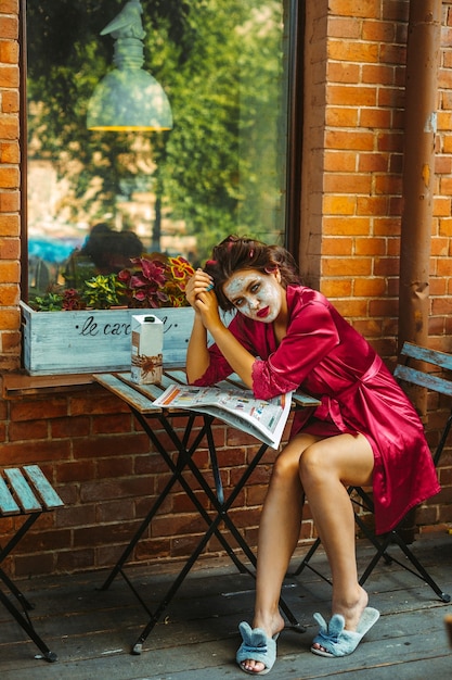 Girl with face mask and bath robe