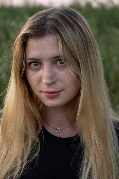 A girl with freckles on a background of flowers