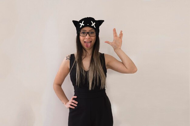 Photo girl with glasses and cat costume isolated on white background