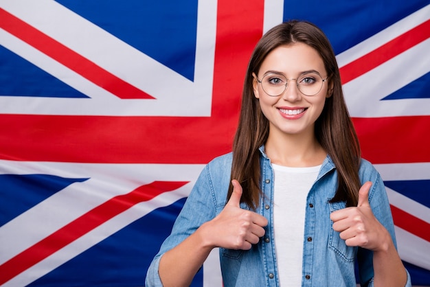 girl with glasses shows thumb up sign