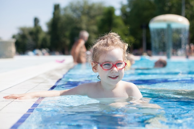 Girl with glasses swimming in the pool