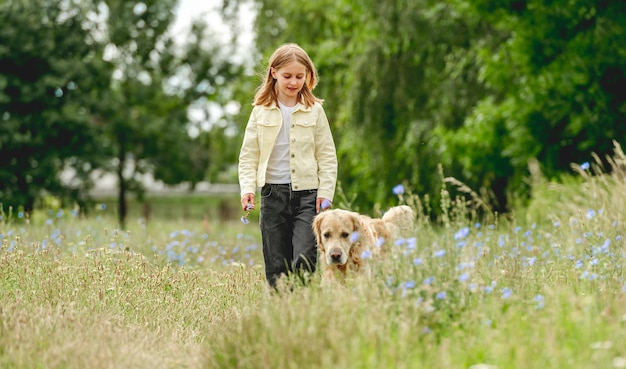 Girl with golden retriever dog