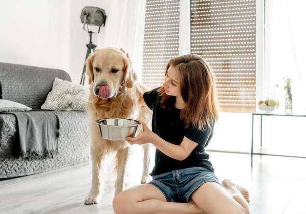 Girl with golden retriever dog