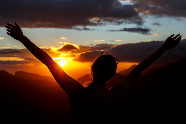 girl with Hands-up at sunset