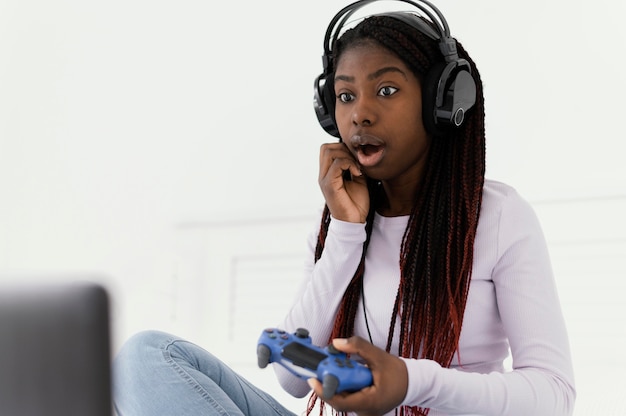 Girl with headphones playing videogame