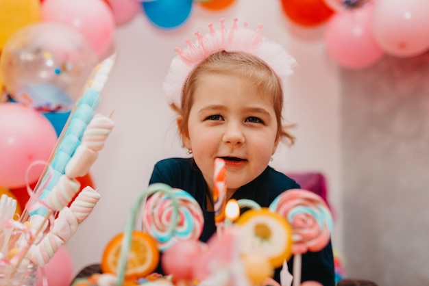 Girl with her birthday cake happy birthday carda cute little girl celebrates birthday surrounded by gifts