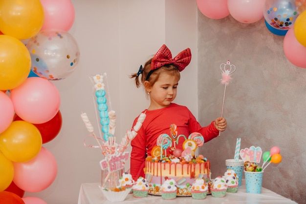 Girl with her birthday cake happy birthday carda cute little girl celebrates birthday surrounded by gifts