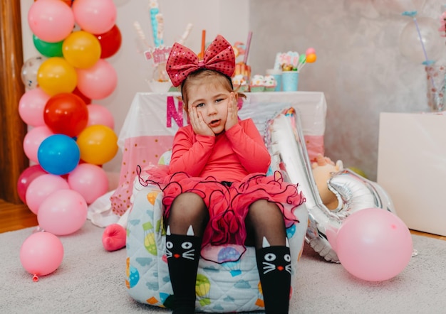 Girl with her birthday cake happy birthday carda cute little girl celebrates birthday surrounded by gifts