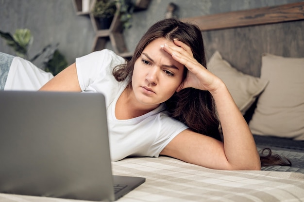 Girl with laptop on bed