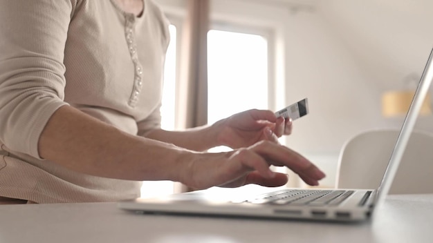 Girl with laptop and credit card shopping online