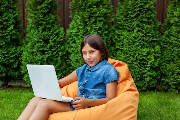 Girl with a laptop in the garden