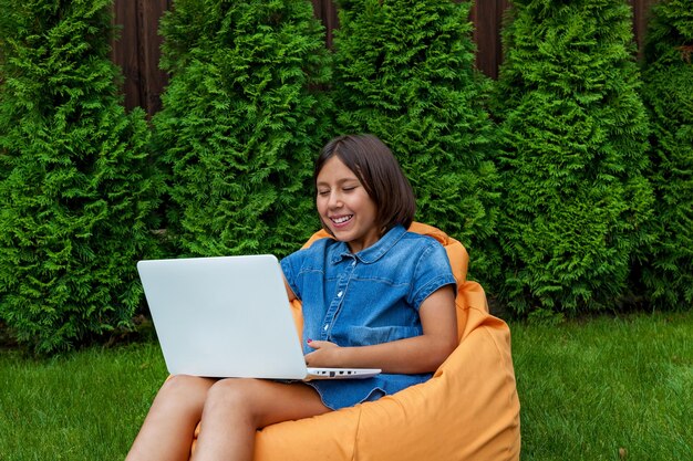 Girl with a laptop in the garden