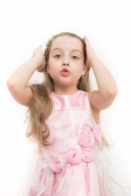 Girl with long blond hair fix earring in pink dress