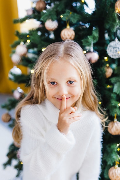 Girl with long hair near the Christmas tree