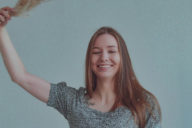 Photo girl with long hair with a branch