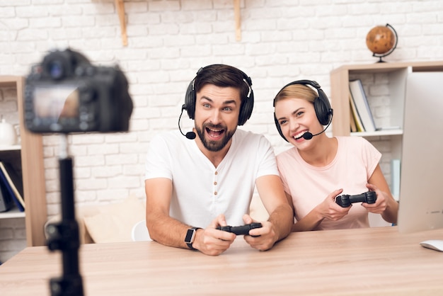 Girl with a man plays video games in the office.