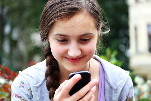 Girl with a mobile phone reads the message