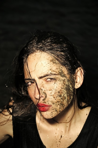 Girl with mud mask on face water