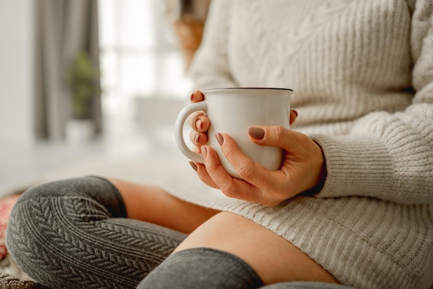 Girl with mug filled with cocoa