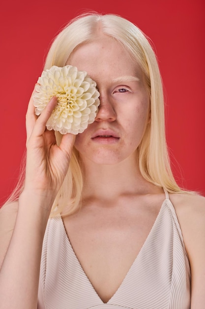 Girl with natural beauty posing with flower