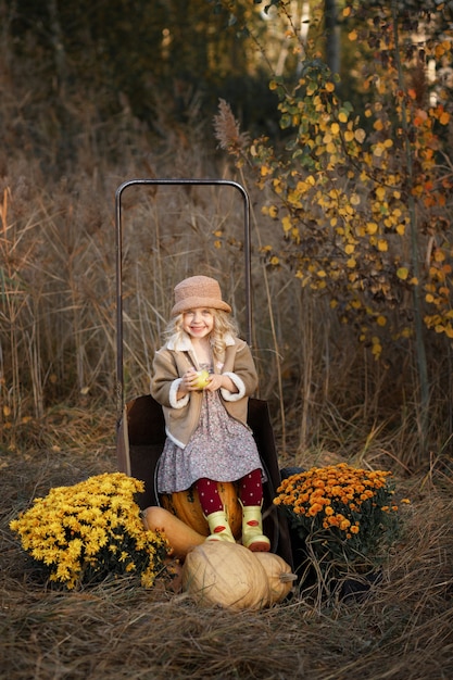 Girl with pumpkins in autumn