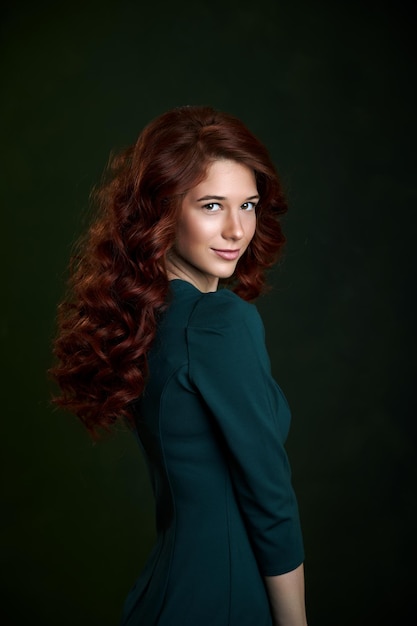 Girl with red hair studio beauty portrait