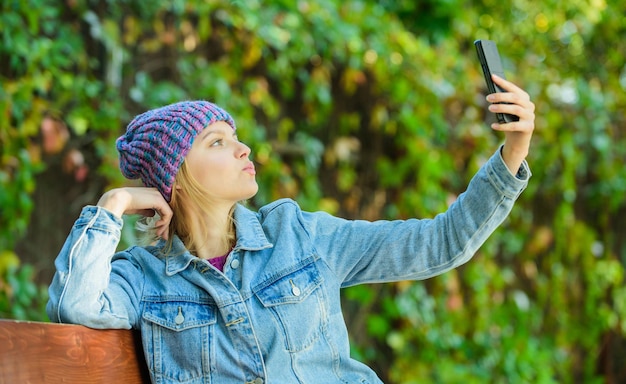 Girl with smartphone green nature background Woman having mobile conversation Mobile communication and social networks Girl call friend Stay touch with modern smartphone Mobile call concept