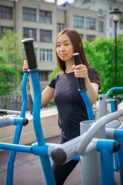 A girl with a sports figure is engaged in a simulator