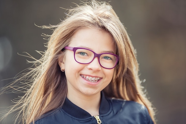 Girl with teeth braces Young cute caucasian blond girl wearing teeth braces and glasses