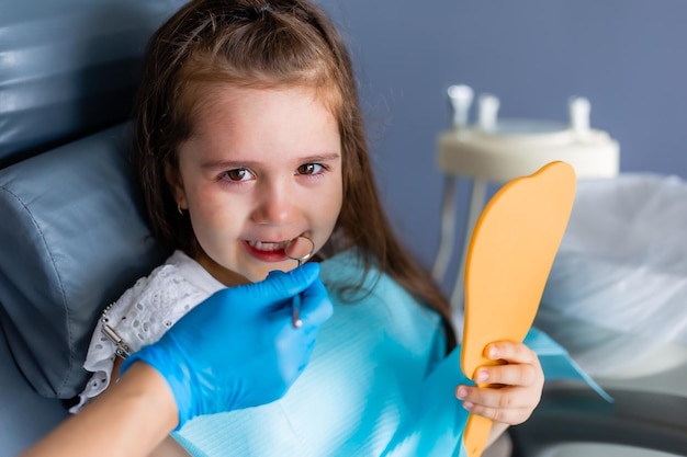 A girl with a toothbrush in her mouth