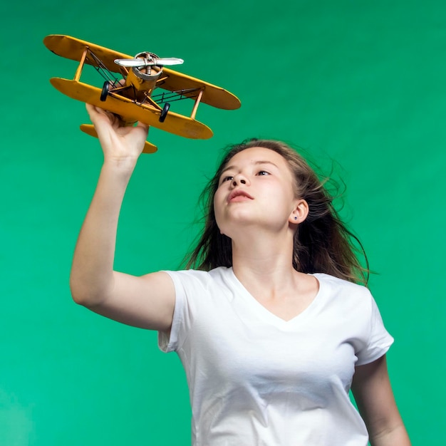 Girl with toy airplane in hand a symbol of dreams and hopes