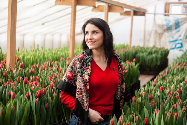 Girl with tulips grown in a greenhouse. 