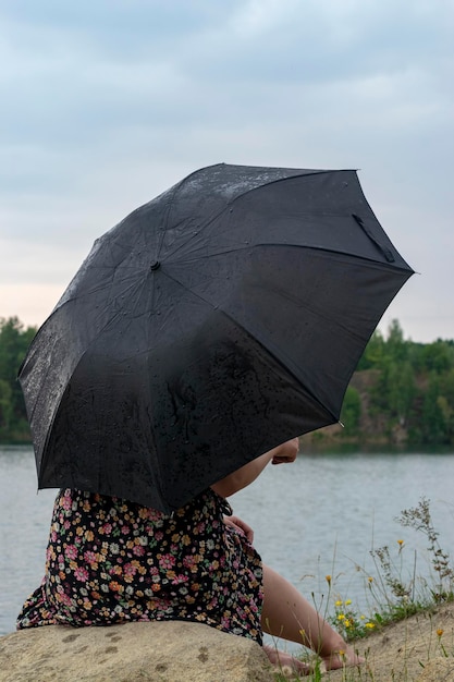 Girl with an umbrella in cloudy weather